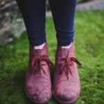 Pink boots standing on green moss