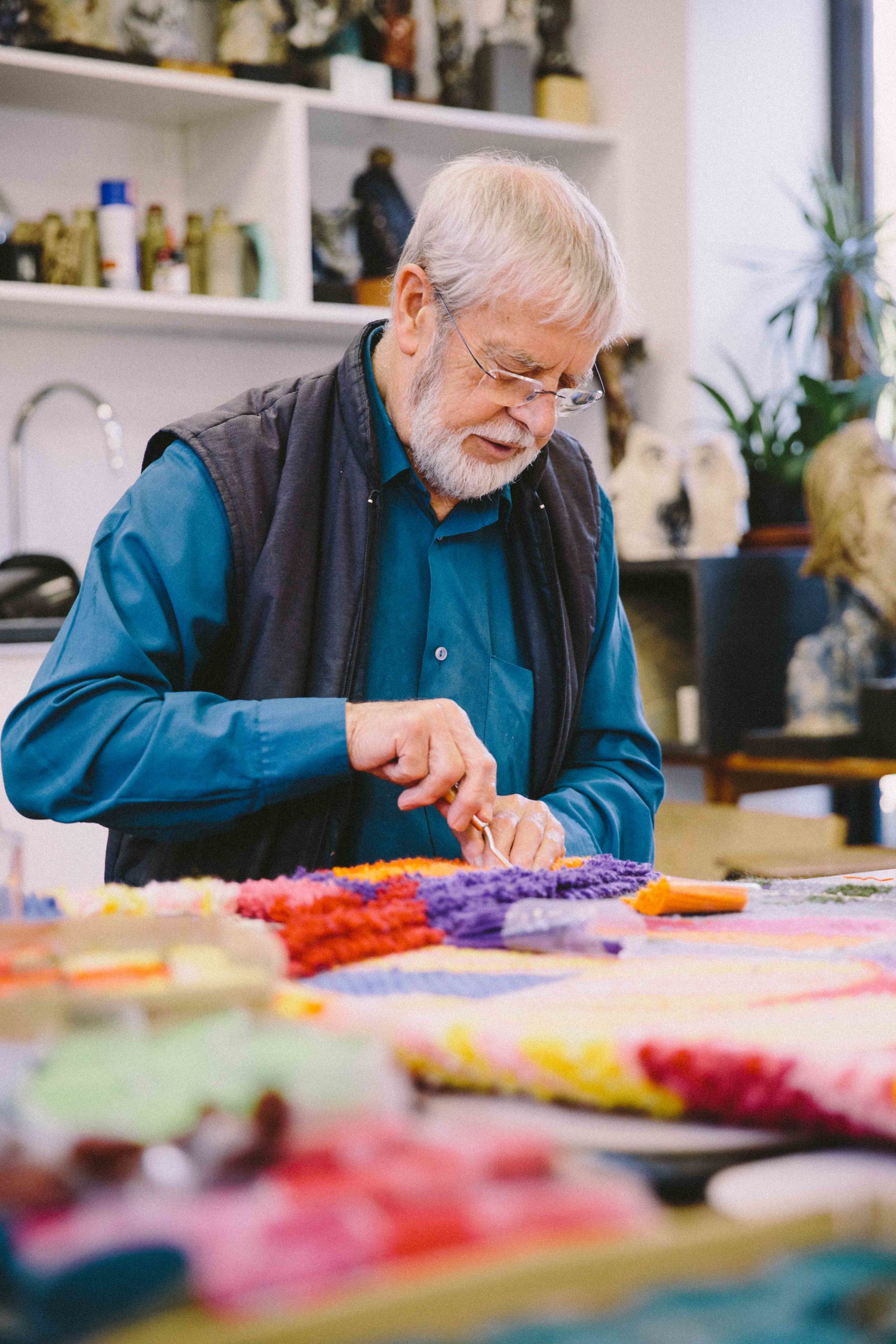 Keith Gretton knotting colour wool into a rug