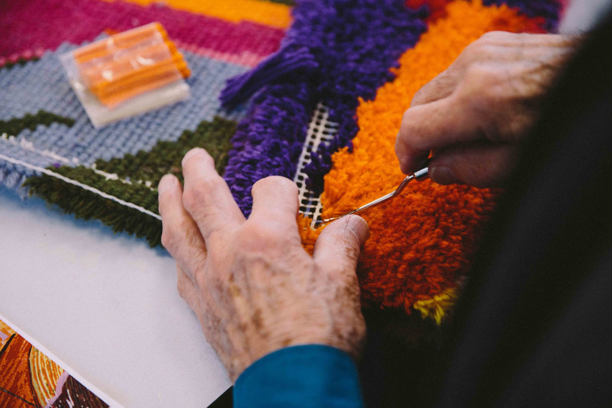 Keith Gretton's hands with colourful wool